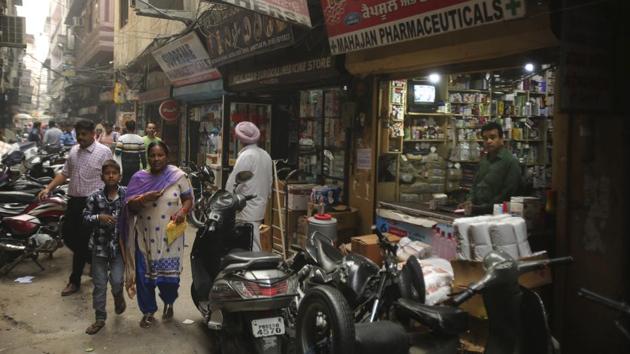 People walk past drugstores where tramadol was once easily accessible in Amritsar, in the northern Indian state of Punjab. The pills were everywhere, as legitimate medication sold in pharmacies, but also illicit counterfeits hawked by itinerant peddlers and street vendors. Grunenthal, the German company that originally made the drug, is campaigning for the status quo, arguing that it’s largely illicit counterfeit pills causing problems. (Channi Anand / AP)