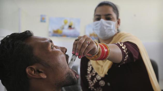 A medic administers medicine to a recovering drug addict. India regulated tramadol in April 2018. Regulators say exports overseas and abuse at home came down. But they acknowledge that the vastness of the pharmaceutical industry and the ingenuity of traffickers makes curtailing abuse and illegal exports all but impossible. Tramadol is still easy to find. (Channi Anand / AP)