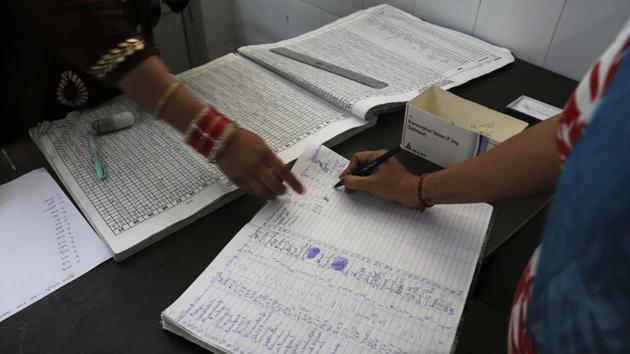 A recovering tramadol drug addict signs a register after taking her medication. Jyoti Rani stood on her front steps and pointed to house after house where she said tramadol is still sold in her neighborhood of narrow roads and open drains, where school-aged boys sit hunched over the street in the middle of a weekday. Rani’s addiction began with heroin. When her 14-year-old son died, she fell into depression. (Channi Anand / AP)