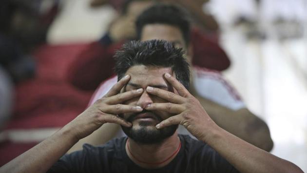 Recovering drug addicts perform yoga at a de-addiction center. India has twice the global average of illicit opiate consumption. Countries’ efforts to control tramadol on their own often fail, particularly in places where addiction has taken hold, according to the Center for Strategic and International Studies. (Channi Anand / AP)
