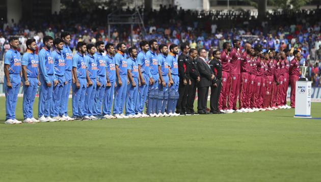 Players of India, left, and West Indies stand for their national anthems before the start of their first one day international cricket match in Chennai, India. (AP)