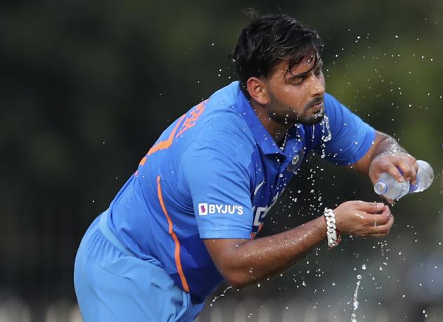 Rishabh Pant splashes cold water on his face during the first one day international cricket match between India and West Indies. (AP)