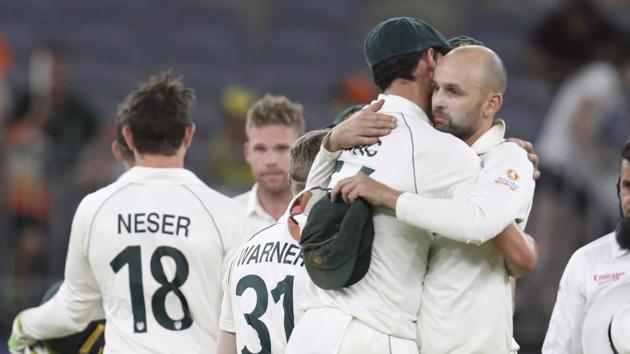 Australian bowlers Mitchell Starc and Nathan Lyon hug after winning their cricket test against New Zealand in Perth.(AP) Australian bowlers Mitchell Starc and Nathan Lyon hug after winning their cricket test against New Zealand in Perth.(AP)