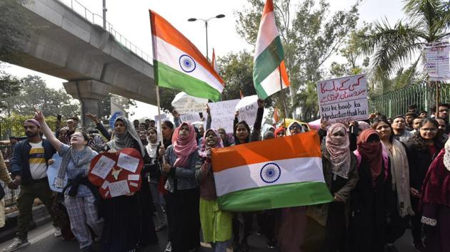 Demonstrators during a protest against the Citizenship Amendment Act (CAA), near Jamia Millia Islamia in New Delhi. (Sanjeev Verma/HT PHOTO) Demonstrators during a protest against the Citizenship Amendment Act (CAA), near Jamia Millia Islamia in New Delhi. (Sanjeev Verma/HT PHOTO)