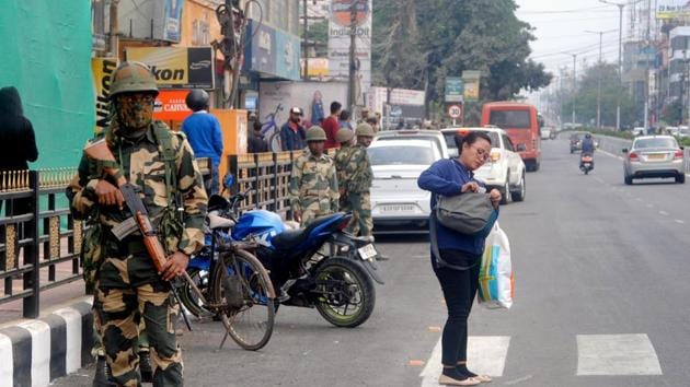 Security personnel stand guard during the curfew relaxation time, in Guwahati.(ANI Photo) Security personnel stand guard during the curfew relaxation time, in Guwahati.(ANI Photo)