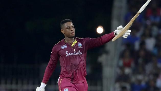 West Indies' Shimron Hetmyer raises his bat to celebrate scoring a century.(AP)