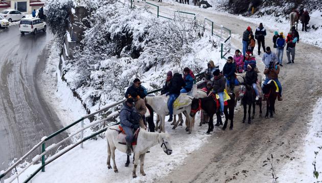 After fresh snowfall, tourists visit Kufri near Shimla on Monday. (HT Photo) After fresh snowfall, tourists visit Kufri near Shimla on Monday. (HT Photo)