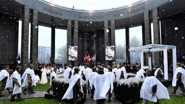 People dressed as WWII US soldiers take part in the 75th commemoration ceremony of the Battle of the Bulge, at the Mardasson Memorial. US Army veteran Malcolm “Buck” Marsh took the tributes in stride Monday as he addressed royalty, military leaders and top government officials. Bent, slow, yet sturdy, the veterans returning to the battlefield continued to amaze the crowds. (John Thys / AFP) People dressed as WWII US soldiers take part in the 75th commemoration ceremony of the Battle of the Bulge, at the Mardasson Memorial. US Army veteran Malcolm “Buck” Marsh took the tributes in stride Monday as he addressed royalty, military leaders and top government officials. Bent, slow, yet sturdy, the veterans returning to the battlefield continued to amaze the crowds. (John Thys / AFP)