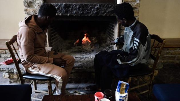 Two migrants sit at a fireplace in the lobby of a disused ski lodge. In the meantime the migrants wonder how they can build a life for them halfway up a Greek mountain. Some want to learn Greek, get a job and live a normal life with their families. Some of their children are 10 and not in school. They aren’t asking for anything outrageous. (Sakis Mitrolidis / AFP) Two migrants sit at a fireplace in the lobby of a disused ski lodge. In the meantime the migrants wonder how they can build a life for them halfway up a Greek mountain. Some want to learn Greek, get a job and live a normal life with their families. Some of their children are 10 and not in school. They aren’t asking for anything outrageous. (Sakis Mitrolidis / AFP)