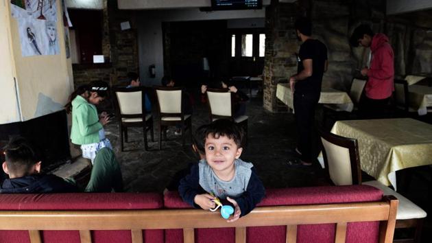 As in most parts of the country, the response here to the presence of asylum-seeker families and unaccompanied minors is mixed. Operators in isolated areas are frequently grateful for any business in the dead of winter, but many elderly locals in sparsely populated villages are fearful. “They keep having children,” says a local tavern owner. “We have a falling birth rate. At this rate, they will eventually take over.” (Sakis Mitrolidis / AFP) As in most parts of the country, the response here to the presence of asylum-seeker families and unaccompanied minors is mixed. Operators in isolated areas are frequently grateful for any business in the dead of winter, but many elderly locals in sparsely populated villages are fearful. “They keep having children,” says a local tavern owner. “We have a falling birth rate. At this rate, they will eventually take over.” (Sakis Mitrolidis / AFP)
