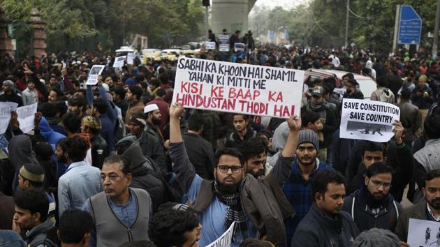 Protesters hold placards against the Citizenship Amendment Act (CAA) and the police crackdown on students, outside Jamia Millia Islamia, Maulana Mohammad Ali Jauhar Marg, in New Delhi, on Monday, December 16, 2019. (Burhaan Kinu/HT PHOTO) Protesters hold placards against the Citizenship Amendment Act (CAA) and the police crackdown on students, outside Jamia Millia Islamia, Maulana Mohammad Ali Jauhar Marg, in New Delhi, on Monday, December 16, 2019. (Burhaan Kinu/HT PHOTO)