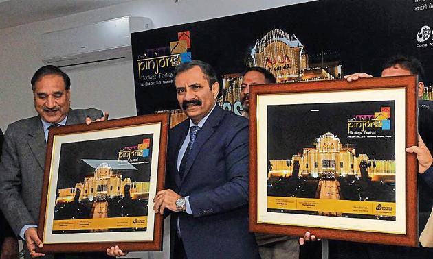 (From left) Haryana Tourism Corporation managing director Vikas Yadav and additional chief secretary, Haryana tourism department, Vijai Vardhan launching the poster of the 12th Pinjore Heritage Festival at Haryana Niwas in Sector 3, Chandigarh, on Wednesday.(HT PHOTO)