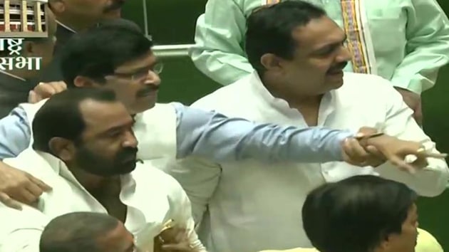 Inside the assembly some of the members waved the posters, and at least a couple of BJP legislators rushed towards the Speaker’s podium raising slogans and demanding immediate implementation of the Sena’s earlier demand. (ANI) Inside the assembly some of the members waved the posters, and at least a couple of BJP legislators rushed towards the Speaker’s podium raising slogans and demanding immediate implementation of the Sena’s earlier demand. (ANI)
