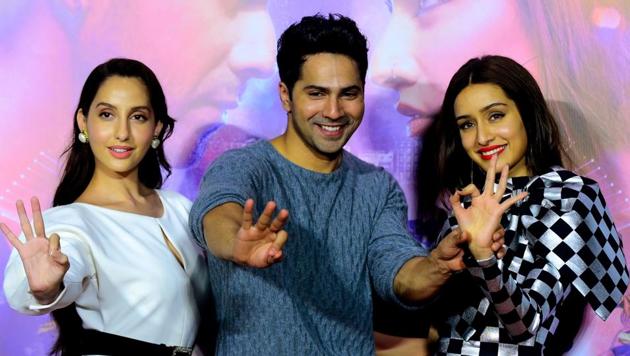 Nora Fatehi (L), Varun Dhawan (C) and Shraddha Kapoor (R) pose for photographs during the trailer launch of the upcoming Hindi dance film Street Dancer 3D in Mumbai on December 18, 2019. (Photo by Sujit Jaiswal / AFP)(AFP)