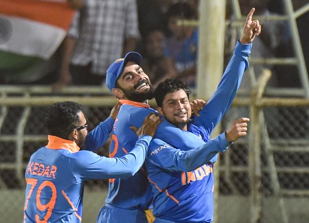 Kuldeep Yadav celebrates with skipper Virat Kohli and teammate Kedar Jadhav after completing his hat-trick. (PTI)