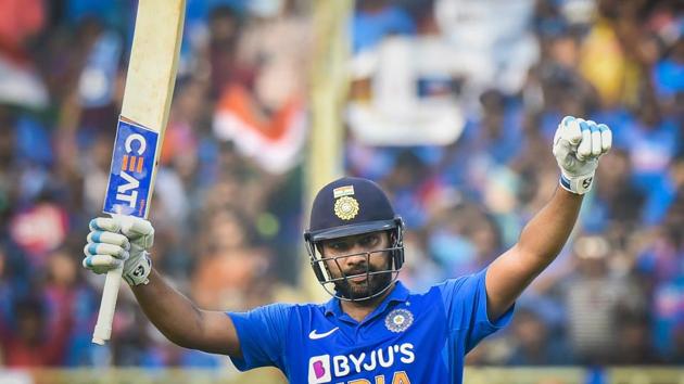 Indian cricketer Rohit Sharma raises his bat after completing a century during the 2nd One Day International cricket match against West Indies at ACA-VDCA Cricket Stadium in Visakhapatnam.(PTI)