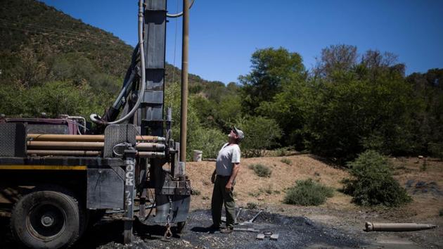 Dwain Wallace, a commercial farmer and the owner of the Waterkloof Farm stares at the drilling machinery that just opened a borehole on his farm in the outskirts of Adelaide. Local authorities have tried to ease the situation by connecting sections of the town to a reservoir fed by Fish River, around 50 kilometres (30 miles) away. (Guillem Sartorio / AFP) Dwain Wallace, a commercial farmer and the owner of the Waterkloof Farm stares at the drilling machinery that just opened a borehole on his farm in the outskirts of Adelaide. Local authorities have tried to ease the situation by connecting sections of the town to a reservoir fed by Fish River, around 50 kilometres (30 miles) away. (Guillem Sartorio / AFP)