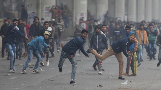 Protestors pelt stones towards police during the protest. Empty tear gas shells, pins of used gas grenades, stones, bricks, broken glass bottles, three burnt bikes and plastic bottles containing a green chemical were scattered for almost a kilometre on both the carriageways of the 66-ft road, between Seelampur Chowk and Jafrabad Metro station. (Sanchit Khanna / HT Photo) Protestors pelt stones towards police during the protest. Empty tear gas shells, pins of used gas grenades, stones, bricks, broken glass bottles, three burnt bikes and plastic bottles containing a green chemical were scattered for almost a kilometre on both the carriageways of the 66-ft road, between Seelampur Chowk and Jafrabad Metro station. (Sanchit Khanna / HT Photo)