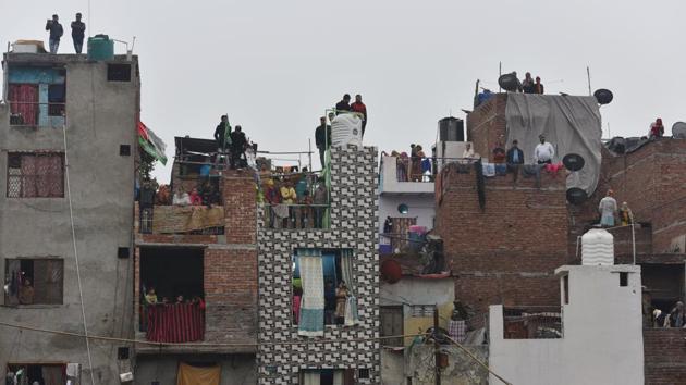 Residents look on as protestors clash with police during the demonstration. Saleem Khan, a Seelampur resident, said till 11am, there were nearly 300 protesters who were marching peacefully. Suddenly, the number of protesters began increasing and by 1.30pm, there was a crowd of over 2,000 people on the road. The protesters were dispersing after culminating their protest at Seelampur Chowk when violence started. (Sanchit Khanna / HT Photo) Residents look on as protestors clash with police during the demonstration. Saleem Khan, a Seelampur resident, said till 11am, there were nearly 300 protesters who were marching peacefully. Suddenly, the number of protesters began increasing and by 1.30pm, there was a crowd of over 2,000 people on the road. The protesters were dispersing after culminating their protest at Seelampur Chowk when violence started. (Sanchit Khanna / HT Photo)