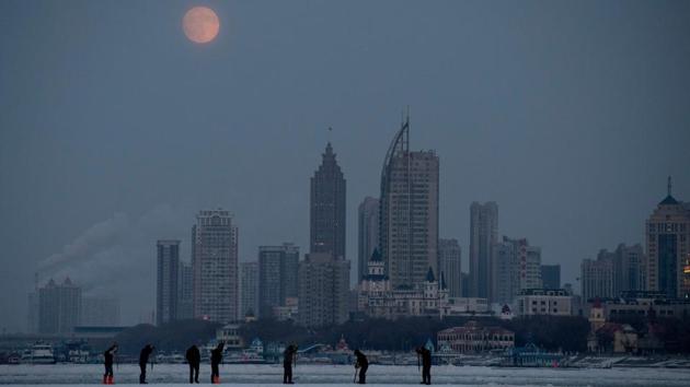 Workers use picks to cut ice blocks from the frozen Songhua river in Harbin, China’s northeastern Heilongjiang province. Liu Yantao and his six co-workers toil on a frozen river in northeast China before dawn, using hand tools and machines to carve large ice bricks for the annual Harbin Ice Festival. (Noel Celis / AFP)
