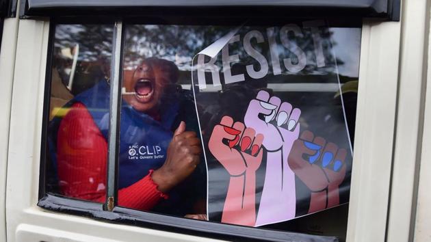 A protester raises slogans after being detained by police for defying imposition of Section 144 during an anti-CAA protest rally in Bengaluru, Karnataka. The police detained one of the country’s most respected historians and intellectuals, Ramachandra Guha during the demonstration in the city. “I am protesting non-violently, but look they are stopping us,” said Guha before being surrounded by police at the demonstration. (Shailendra Bhojak / PTI) 