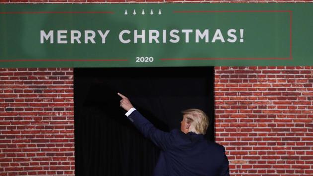 President Donald Trump points as he leaves a campaign rally in Battle Creek, Michigan, on Wednesday. In an extraordinary split screen moment, as the House was casting votes to impeach him, thousands of Trump’s most fervent supporters were cheering him at a rally in Michigan where he railed against a “radical left” he said was “consumed with hatred.” (Paul Sancya / AP)