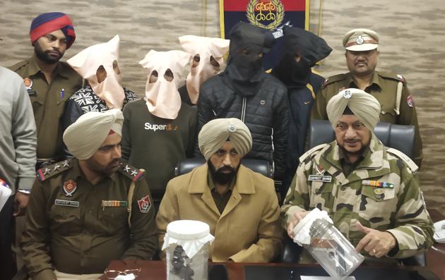 The accused (masked) in police custody in Ludhiana on Thursday. (Harsimar Pal Singh/HT) The accused (masked) in police custody in Ludhiana on Thursday. (Harsimar Pal Singh/HT)
