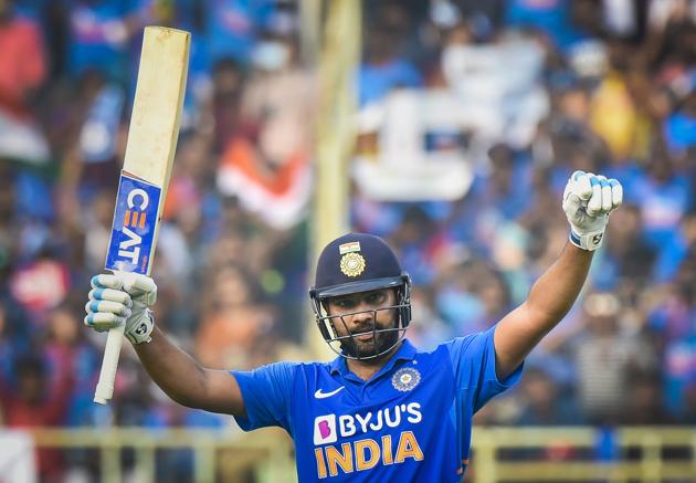 Rohit Sharma raises his bat after completing a century during the 2nd One Day International cricket match against West Indies. (PTI)