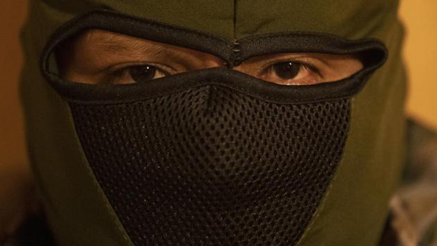 In this Oct. 31, 2019 photo, a Mexican smuggler poses for photos after giving an interview in Nogales, Sonora state, Mexico. The smuggler who did not want to be identified, said that he pays a license fee to the Sinaloa cartel in order to operate in Nogales and he is only allowed to smuggle Mexican nationals across the Mexico - U.S. border. If he wanted to move other nationalities his license fee would go up. (AP) In this Oct. 31, 2019 photo, a Mexican smuggler poses for photos after giving an interview in Nogales, Sonora state, Mexico. The smuggler who did not want to be identified, said that he pays a license fee to the Sinaloa cartel in order to operate in Nogales and he is only allowed to smuggle Mexican nationals across the Mexico - U.S. border. If he wanted to move other nationalities his license fee would go up. (AP)
