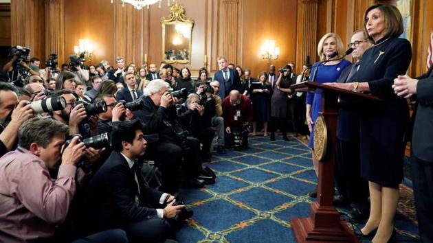 Pelosi speaks to the media after the voting. Both sides were already gearing up for a battle over the Senate trial, where Republican Majority Leader Mitch McConnell has the upper hand in setting rules and has already said he will coordinate with Trump’s team. That could lead to a trial as short as two weeks, which by acquitting the president could turn impeachment into a political win in the run-up to the November 2020 election. (Joshua Roberts / REUTERS)