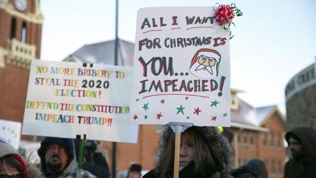 Anti-Trump protesters gather outside at Monument Park on Wednesday in Battle Creek, Michigan. Democrats said they had “no choice” but to formally charge the 73-year-old Republican, whose impeachment along stark party lines places an indelible stain on his record while driving a spike ever deeper into the US political divide. (Nuccio DiNuzzo / Getty Images / AFP)