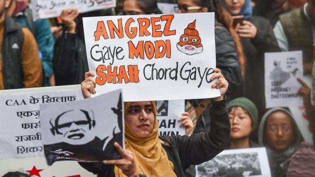 A protester holds a placard at Jantar Mantar. The CAA grants speedier citizenship to non-Muslim refugees from Pakistan, Bangladesh and Afghanistan if they had to leave their respective countries due to religious persecution. This law goes against the secular fabric of India, as enshrined in the constitution. (Manvender Vashist / PTI) 