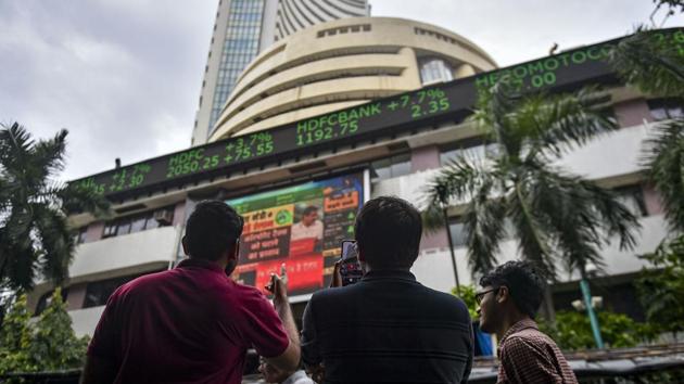 Bystanders react as they watch the stock prices displayed on a digital screen outside BSE building, in Mumbai. (PTI/ File Photo) Bystanders react as they watch the stock prices displayed on a digital screen outside BSE building, in Mumbai. (PTI/ File Photo)