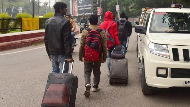 Students of Aligarh Muslim University seen leaving for home after hostels were vacated by authorities.(ANI Photo)