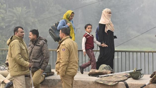 A school student on his way back home with two women, as police personnel stand guard at Shaheenbagh, Okhla, in New Delhi. On Thursday, entry and exit at 20 metro stations were curtailed. These include, Jamia Millia Islamia, Jasola Vihar-Shaheen Bagh, Munirka, Red Fort, Chandni Chowk, Jama Masjid and Vishwavidyalaya. According to Delhi Metro Rail Corporation (DMRC) officials, this was the biggest curtailment of metro operations since its inception in 2002. (Sanjeev Verma / HT Photo) A school student on his way back home with two women, as police personnel stand guard at Shaheenbagh, Okhla, in New Delhi. On Thursday, entry and exit at 20 metro stations were curtailed. These include, Jamia Millia Islamia, Jasola Vihar-Shaheen Bagh, Munirka, Red Fort, Chandni Chowk, Jama Masjid and Vishwavidyalaya. According to Delhi Metro Rail Corporation (DMRC) officials, this was the biggest curtailment of metro operations since its inception in 2002. (Sanjeev Verma / HT Photo)