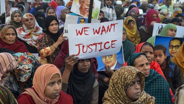 Protestors hold placards during a demonstration against the Citizenship Amendment Act (CAA) at Jamia Nagar. (PTI)