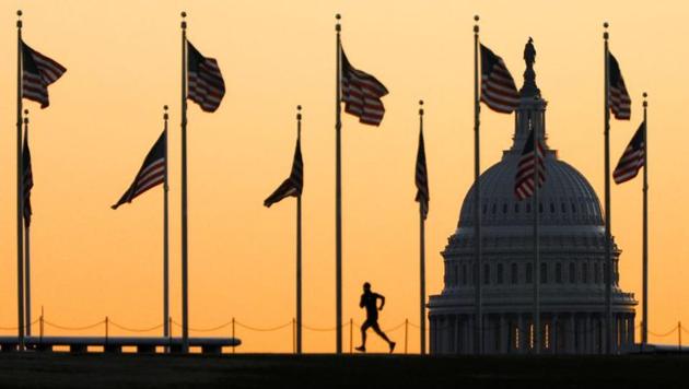 A jogger runs along the Washington Monument at sunrise following the US House of Representatives previous-day vote to impeach US President Donald Trump, in Washington. (Photo: REUTERS) A jogger runs along the Washington Monument at sunrise following the US House of Representatives previous-day vote to impeach US President Donald Trump, in Washington. (Photo: REUTERS)