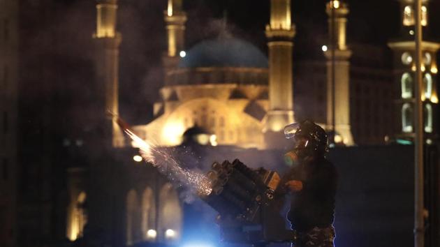 A riot police officer fires tear gas from a launcher against anti-government protesters trying to enter parliament square in downtown Beirut, Lebanon. The recent clashes marked some of the worst in the capital since demonstrations began two months ago. The rise in tensions comes as politicians have failed to agree on forming a new government. (Hussein Malla / AP) A riot police officer fires tear gas from a launcher against anti-government protesters trying to enter parliament square in downtown Beirut, Lebanon. The recent clashes marked some of the worst in the capital since demonstrations began two months ago. The rise in tensions comes as politicians have failed to agree on forming a new government. (Hussein Malla / AP)