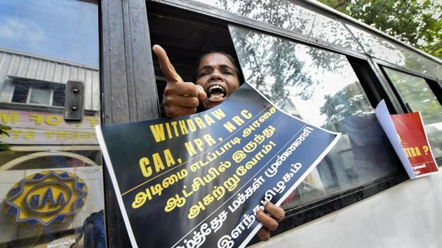A detained protestor raises slogans in Chennai. Various groups like the All India Democratic Women’s Association (AIDWA), Students’ Federation of India (SFI) and Democratic Youth Federation of India (DYFI) participated in the protest. All organisations were seen shouting anti-CAA slogans in unison and holding placards in opposition of the newly passed legislation. (R Senthil Kumar / PTI)