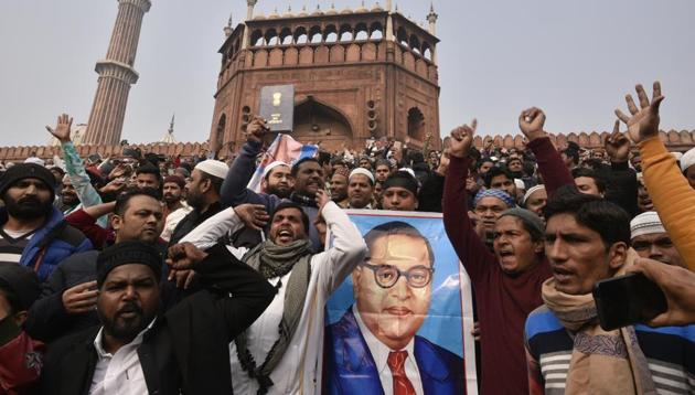 People hold placards and raise slogans during a protest against CAA, at Jama Masjid, in New Delhi, India, on Friday, December 20, 2019.(Biplov Bhuyan/HT PHOTO)