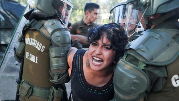 A demonstrator is detained by members of the security forces during a protest against Chile’s government in Santiago, Chile. (Ivan Alvarado / REUTERS) A demonstrator is detained by members of the security forces during a protest against Chile’s government in Santiago, Chile. (Ivan Alvarado / REUTERS)