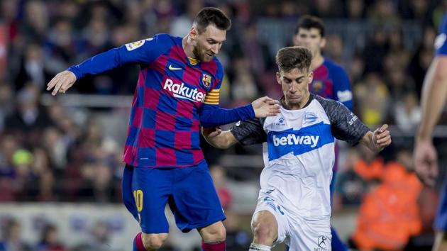 Barcelona's Lionel Messi, left, fights for the ball.(AP)