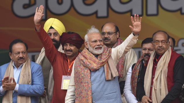 Prime Minister Narendra Modi waves at people during a rally at Ramlila Maidan in New Delhi on Sunday.((Burhaan Kinu/HT PHOTO.))