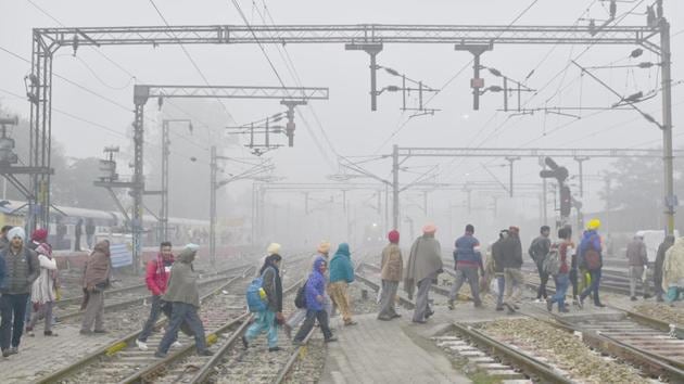 People seen a crossing railways track on a cold and foggy morning, at the railway station in Amritsar, Punjab. (Sameer Sehgal / HT Photo) People seen a crossing railways track on a cold and foggy morning, at the railway station in Amritsar, Punjab. (Sameer Sehgal / HT Photo)