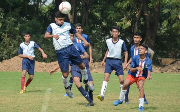 Players from Vidya Bhavan (in dark blue) in action against players from Hutchings High School during the U-16 match of the Loyola football cup at Loyola School, Pashan on Saturday.(Milind Saurkar/HT Photo)