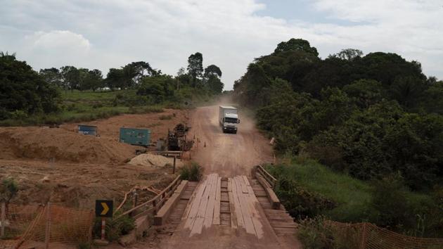 A truck drives on the road in Ruropolis where the highways first meet, and the military government promised land to lure people to the planned agricultural village. One 53-year-old man, Hilquias Soares, remembers a state agent in his hometown yelling, “Who wants to go to Para?” His family took the chance, arriving just after President Emílio Médici, a general, inaugurated the town. (Leo Correa / AP)