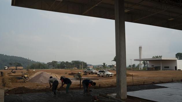 Paving BR-163 ensures soy and corn can flow uninterrupted, making viable more farming and new riverside terminals, where the government says exports can reach 25 million tons in 2024, from 10 million tons this year. More soy means more transport. Workers recently spread concrete at one gas station being built near the crossroads, with parking for 760 trucks. (Leo Correa / AP)
