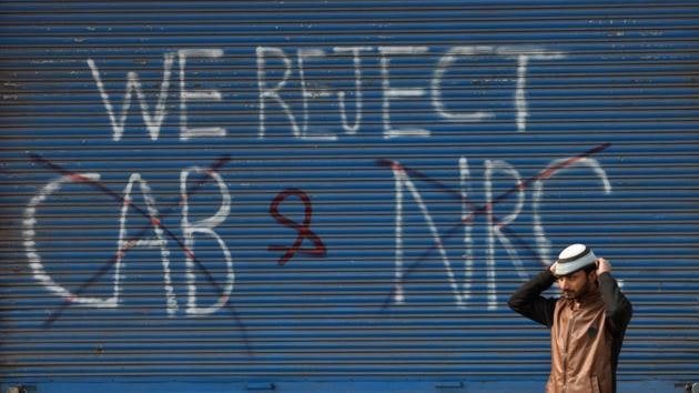 A man walks past graffiti against the new Citizenship Amendment Act and National Register of Citizens is seen in Seelampur area, in New Delhi. (Sanchit Khanna / HT Photo) A man walks past graffiti against the new Citizenship Amendment Act and National Register of Citizens is seen in Seelampur area, in New Delhi. (Sanchit Khanna / HT Photo)