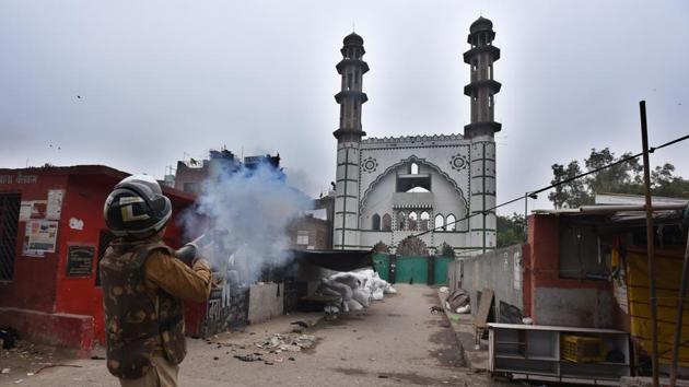 A police personnel fires tear gas to disperse demonstrators protesting against the Citizenship Amendment Act (CAA) at Seelampur in East Delhi. (Raj K Raj / HT Photo) A police personnel fires tear gas to disperse demonstrators protesting against the Citizenship Amendment Act (CAA) at Seelampur in East Delhi. (Raj K Raj / HT Photo)