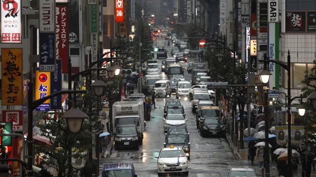 Taxis drive on a narrow street in Tokyo's Shimbashi neighborhood. “Japanese people have a pride in this service,” Norihito said in an interview with The Associated Press. “In the western notion, an individual is independent. But we Japanese are homogeneous. We think of each other as part of the society, the community. So the honor we get as a group is part of the honor each member gets.” (Jae C. Hong / AP) 